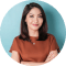 portrait confident smiling asian woman standing with arms folded looking camera isolated blue background